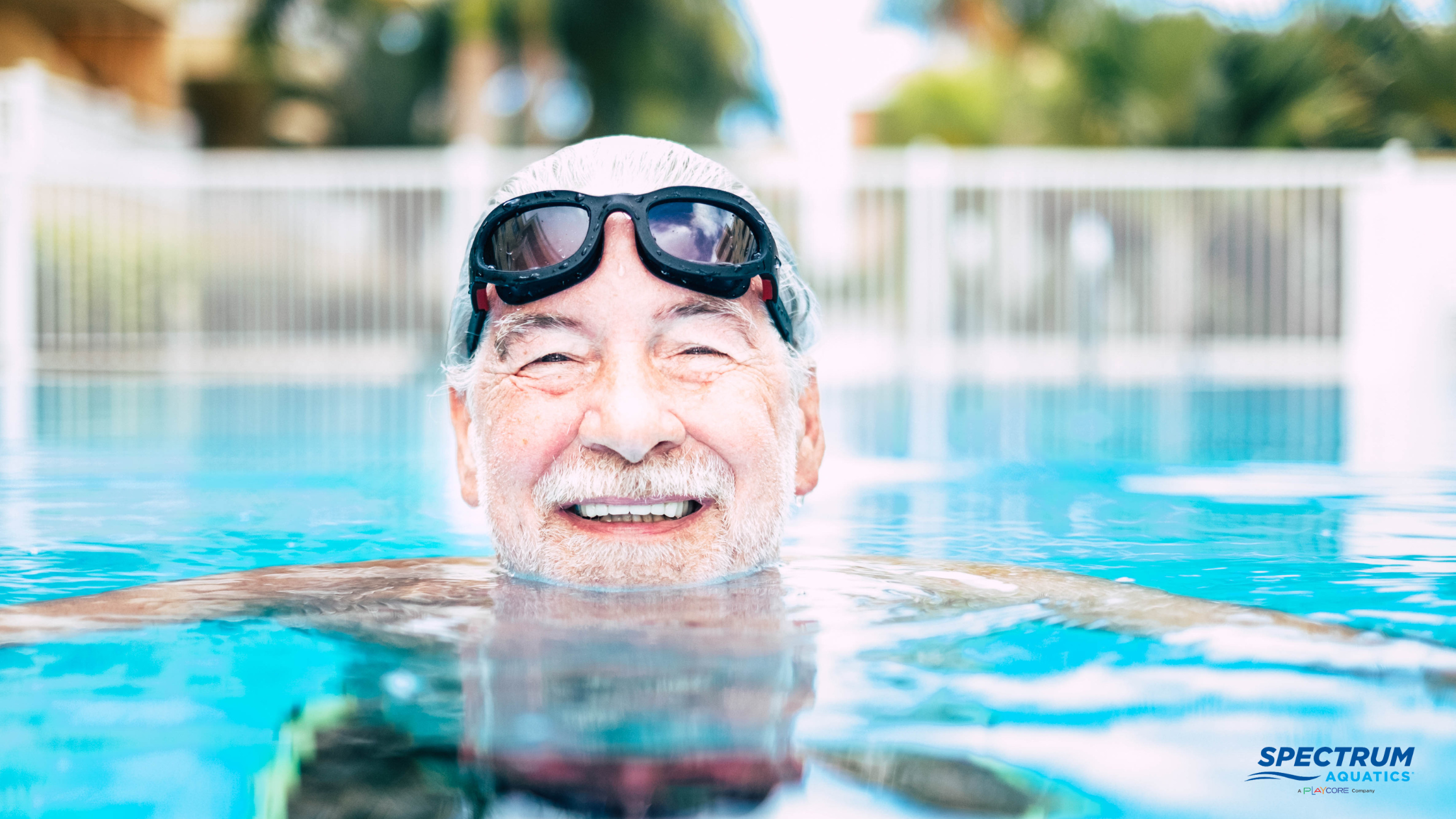 Older man with goggles in swimming pool