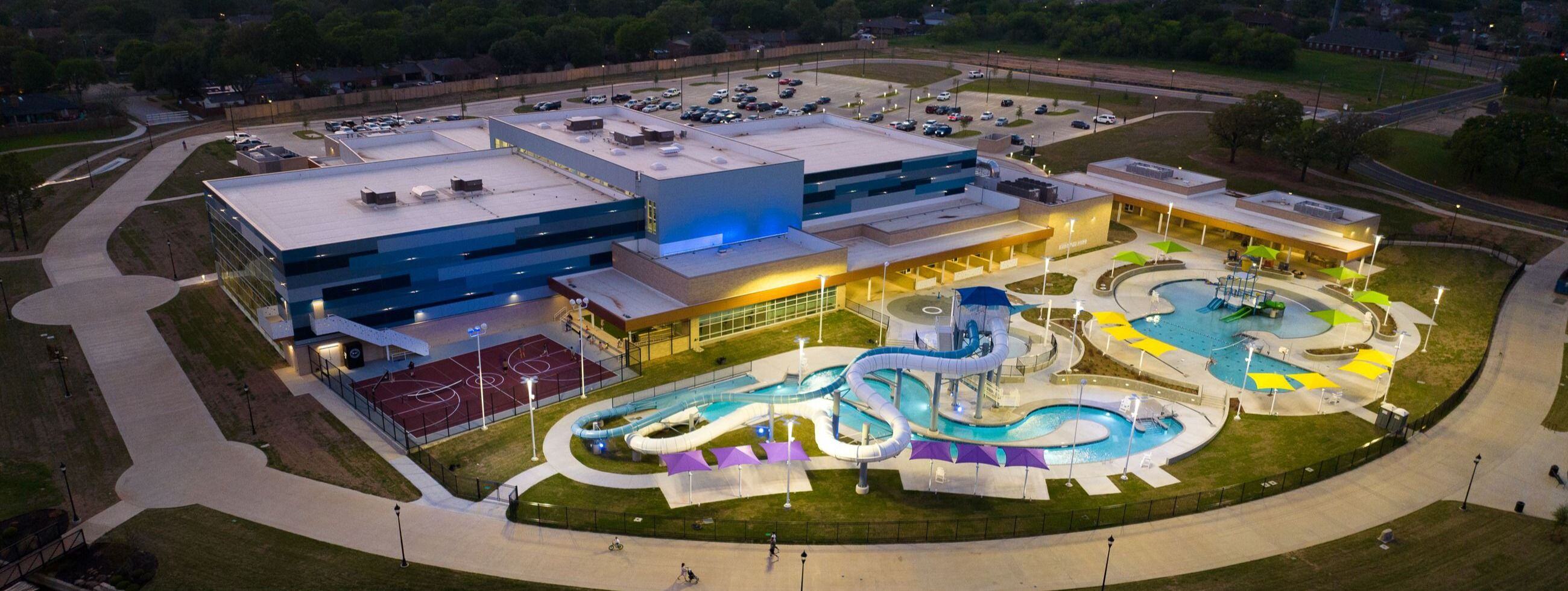 Outdoor recreational aquatic center with a lazy river and water slides