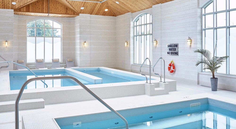 Hand-polished stainless steel pool handrails at indoor spa