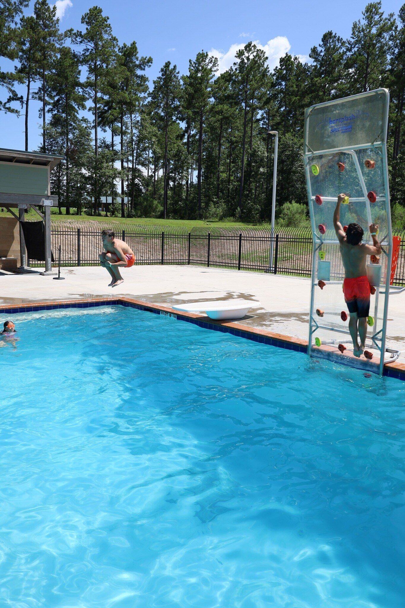 Child climbing Kersplash pool climbing wall
