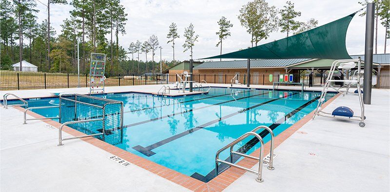 Outdoor pool with Kersplash pool climbing rock walls and stainless steel pool rails