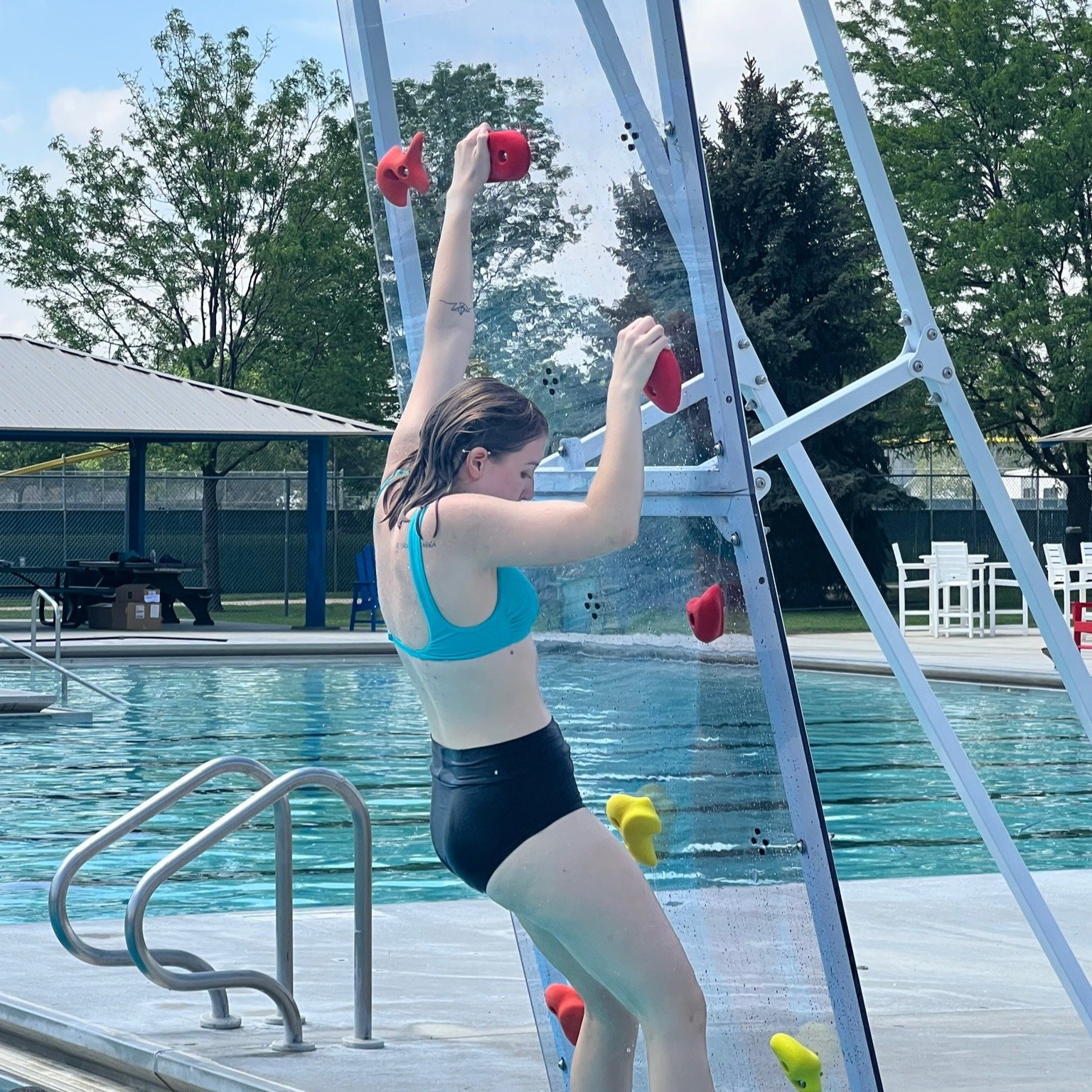 Girl climbing a Kersplash Challenger Pool Climbing Wall