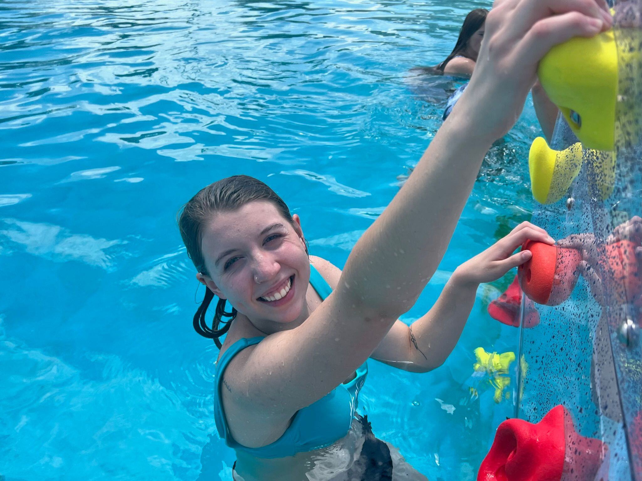 Young lady on KERSPLASH Challenger Pool Climbing Wall