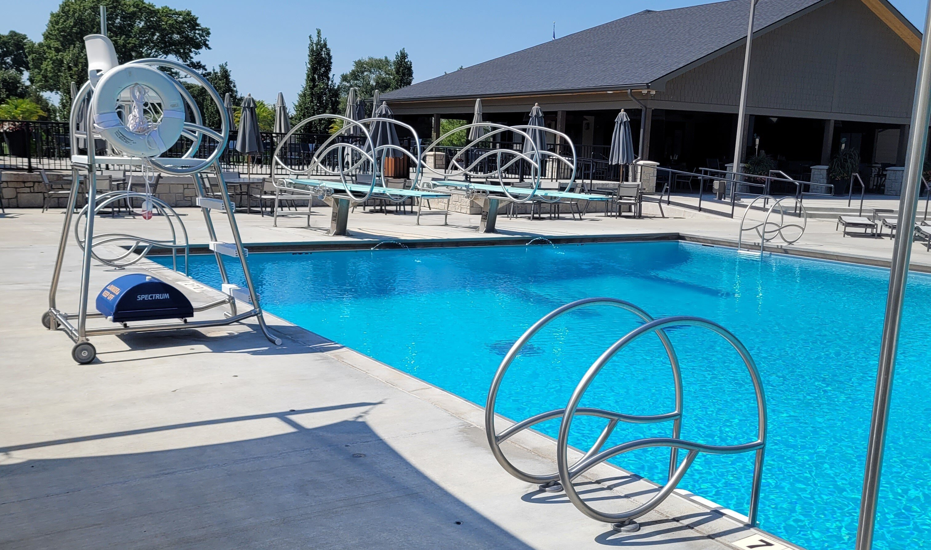 Solarian Stainless Steel Rails and Lifeguard Chairs at outdoor pool