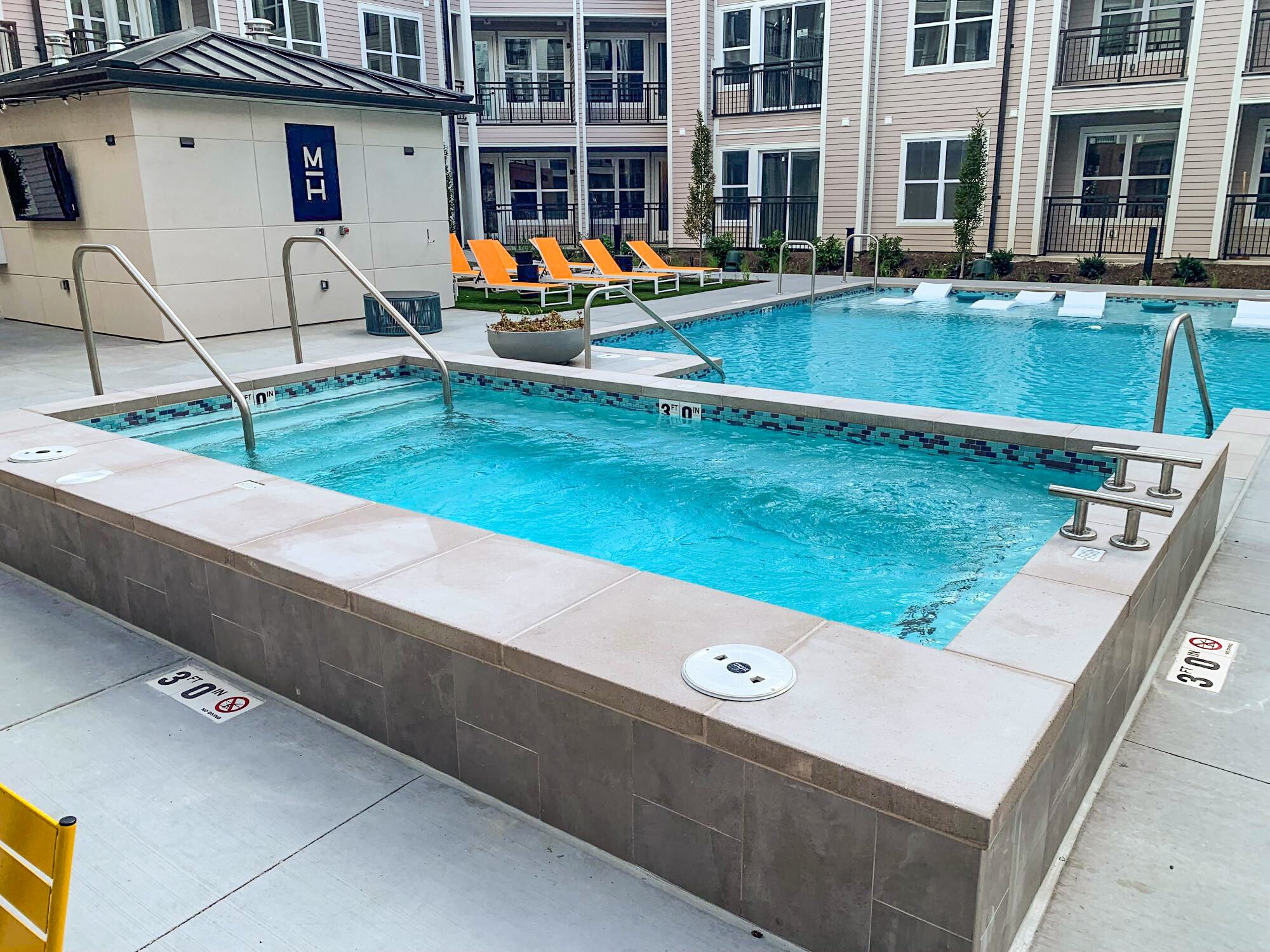 Outdoor pool at apartment complex with stainless steel rails