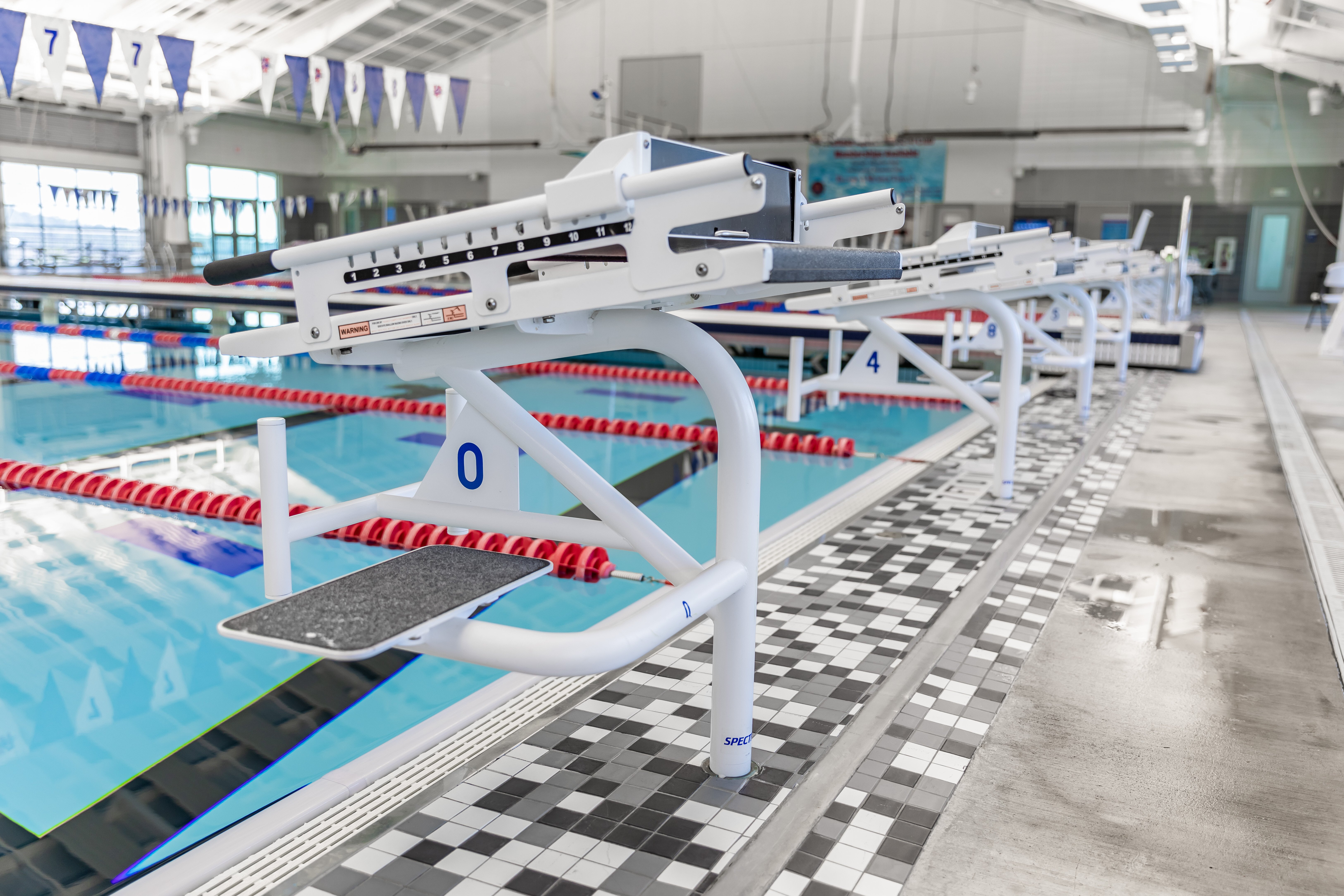 Custom power coated Xcellerator Single Post Xcellerator swimming starting blocks at indoor pool
