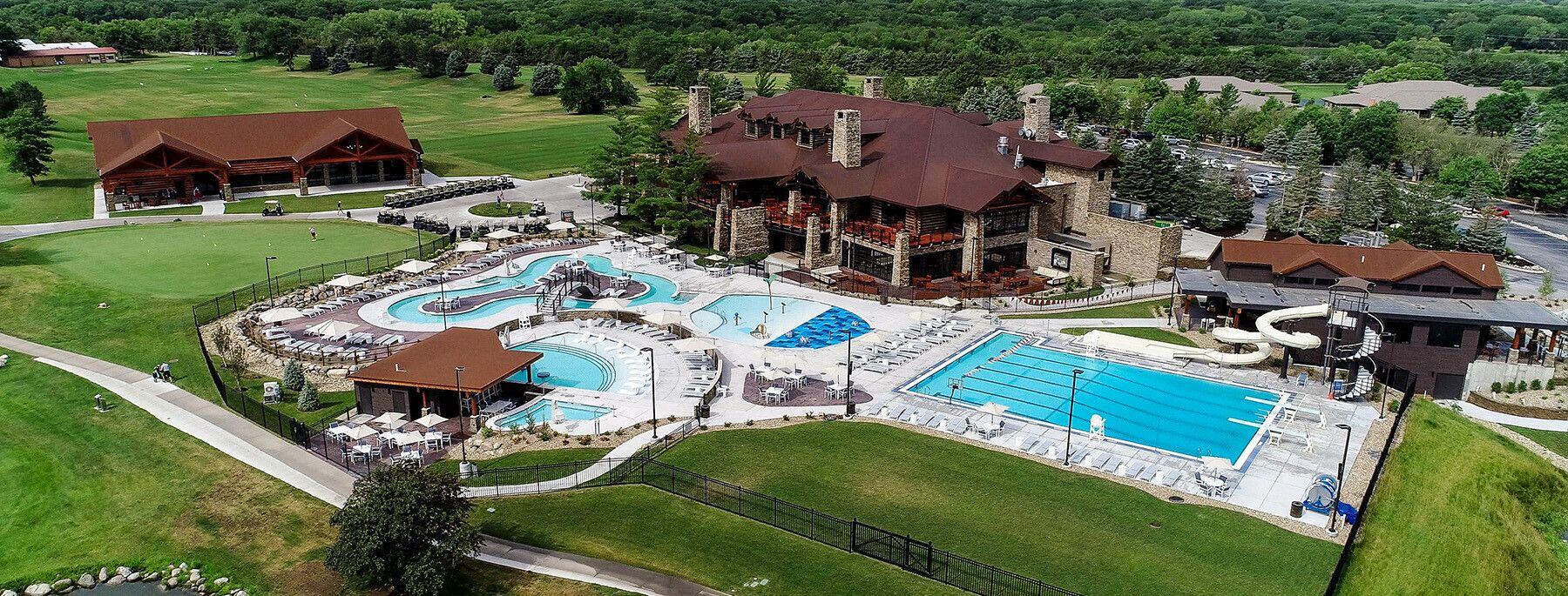 Outdoor pool and splash pad with stainless steel handrails