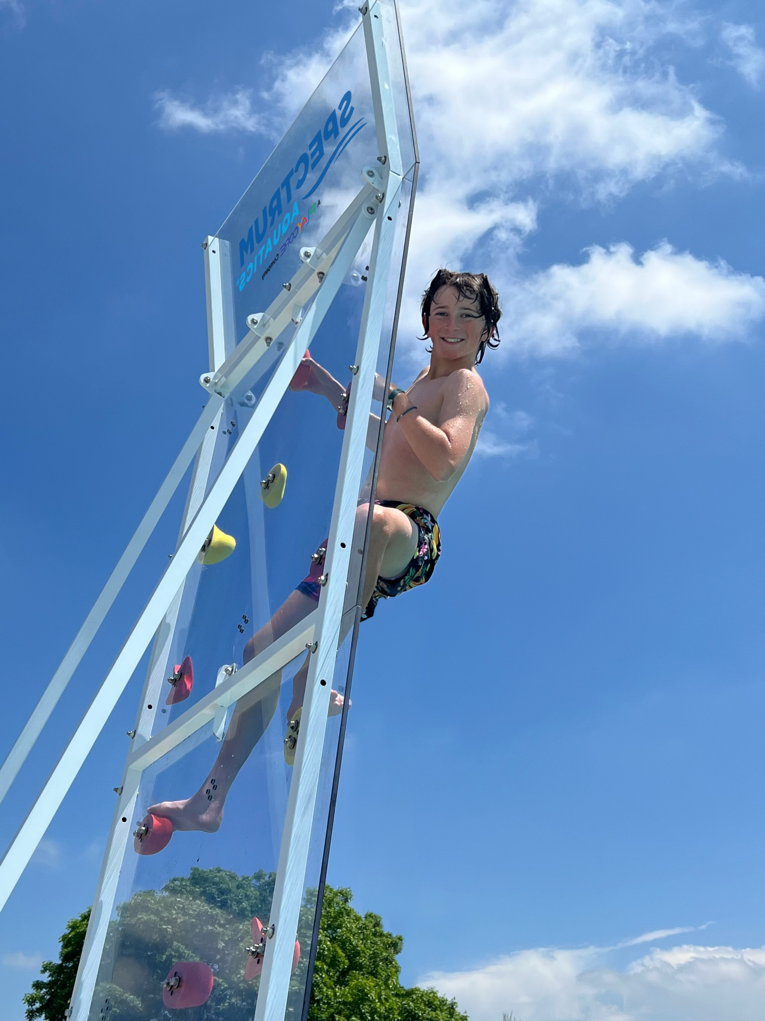 Teen climbing Kersplash Challenger Pool Climbing Wall