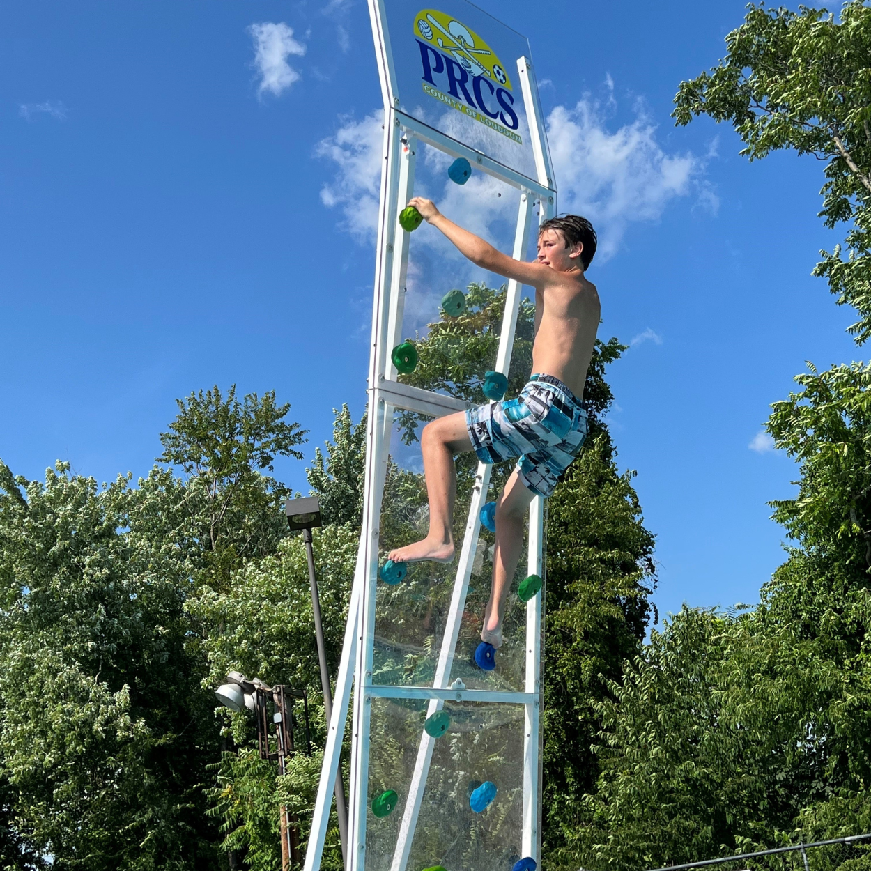 Child on AquaClimb® Krstal, the best Pool Climbing Walls