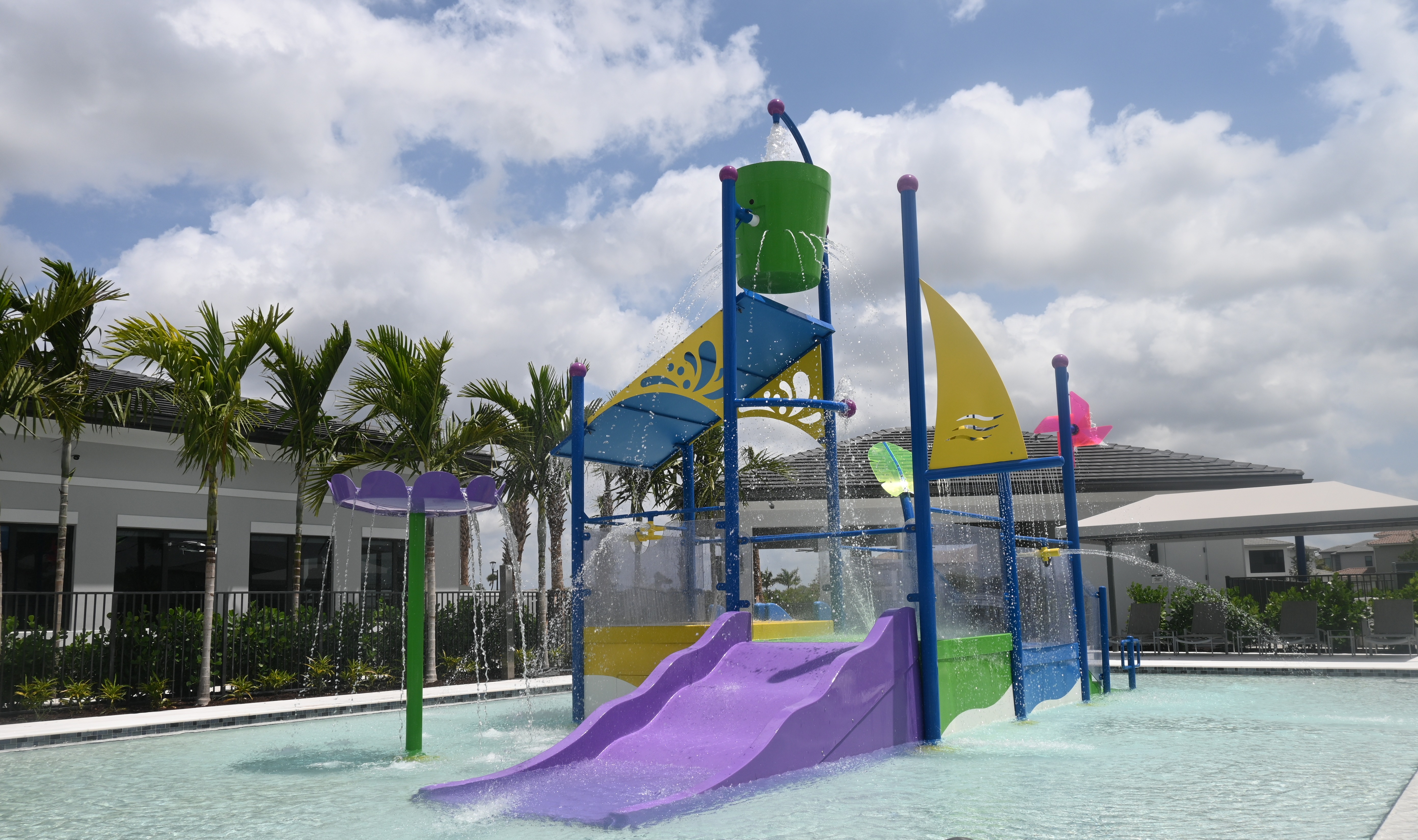 The SlideWorx Kiddie Slide customized to include an entire play structure with dumping buckets and spraying water