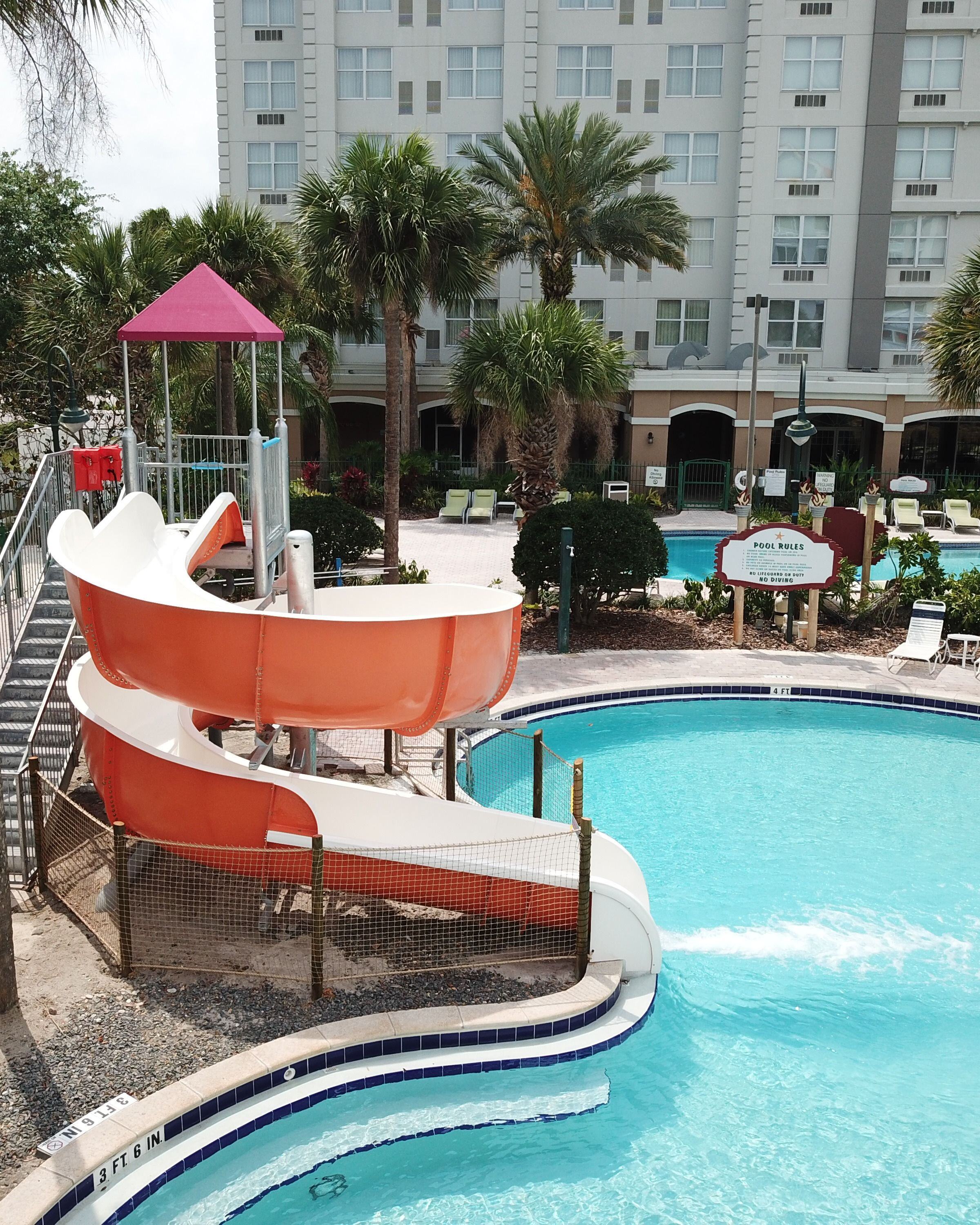 SlideWorx Series Open Single Flume Poolside Slide at outdoor pool