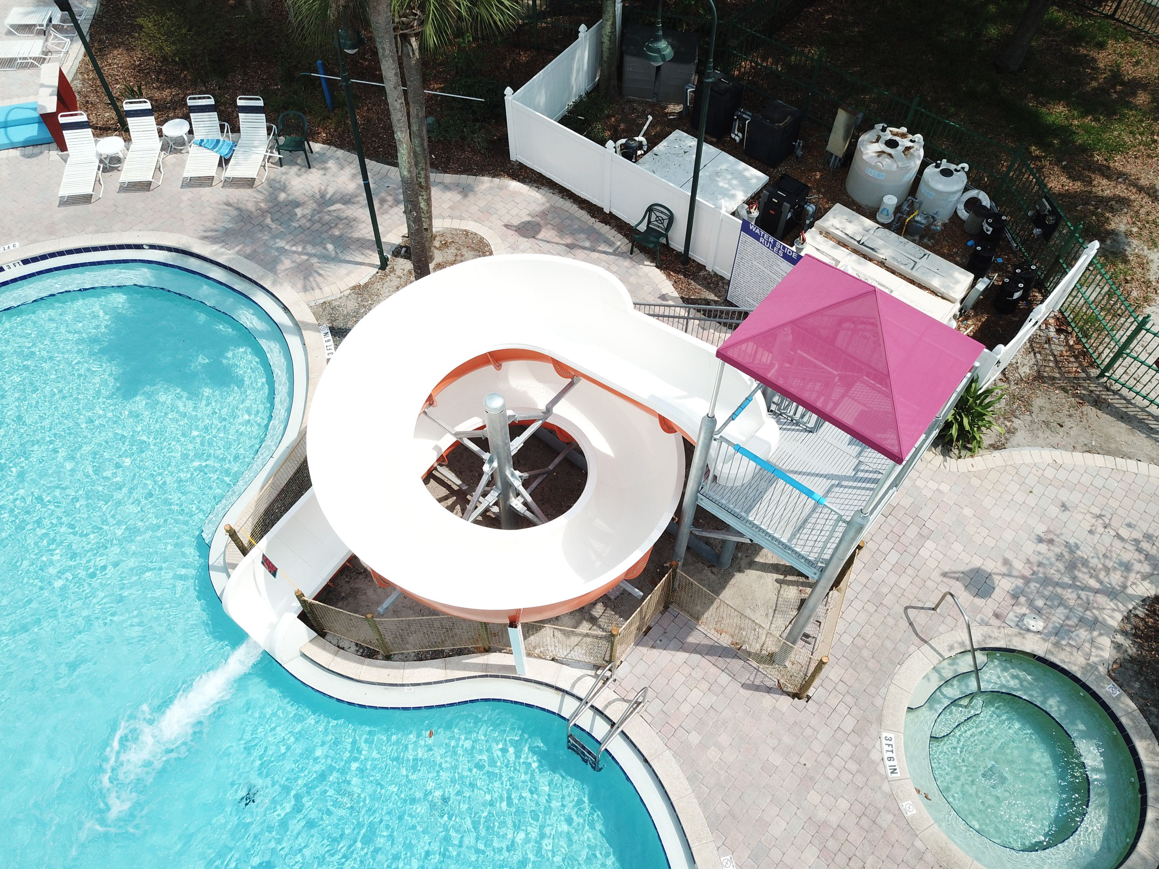 SlideWorx Series Open Single Flume Poolside Slide at outdoor pool