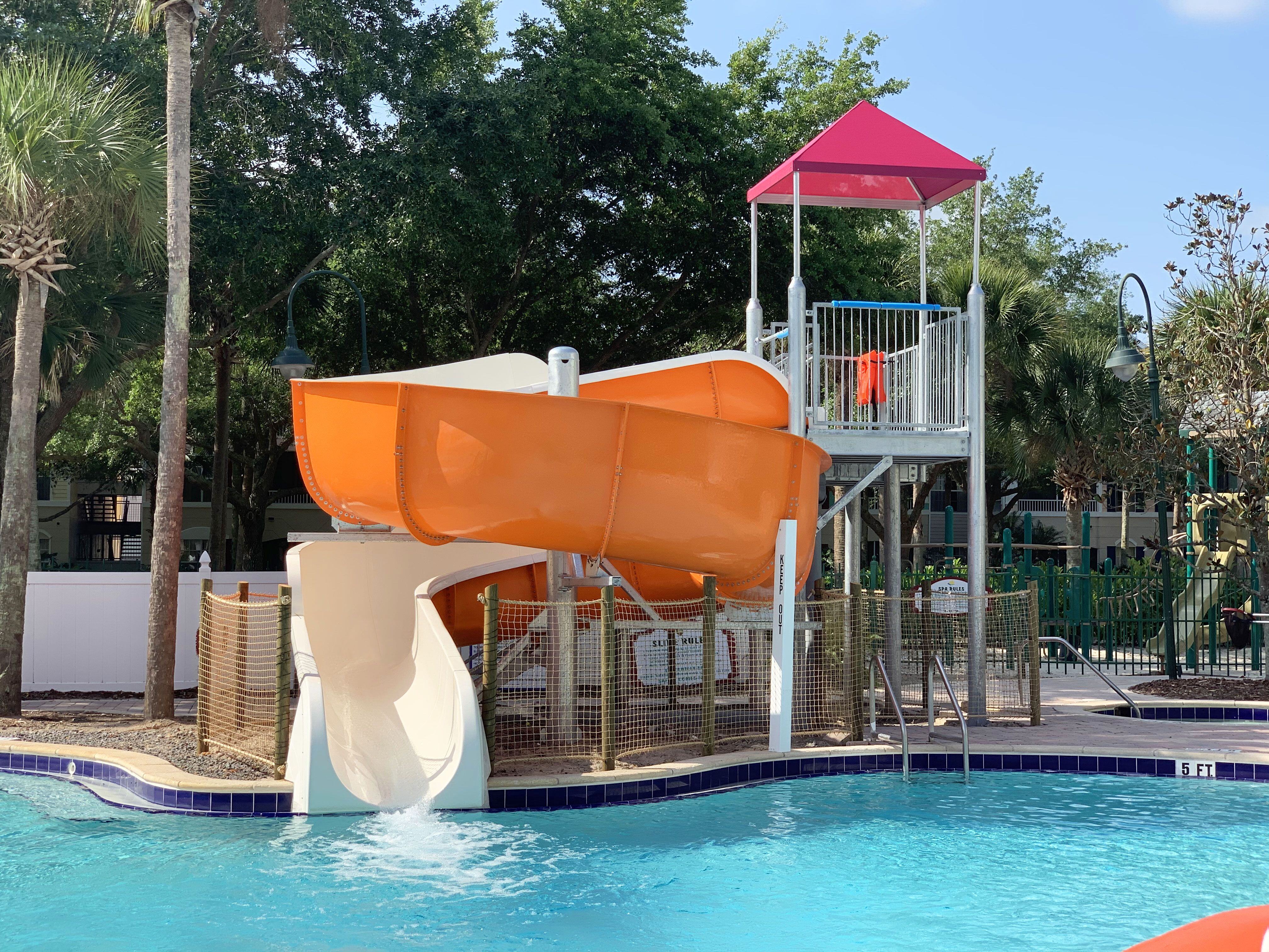 SlideWorx Series Open Single Flume Poolside Slide at outdoor pool