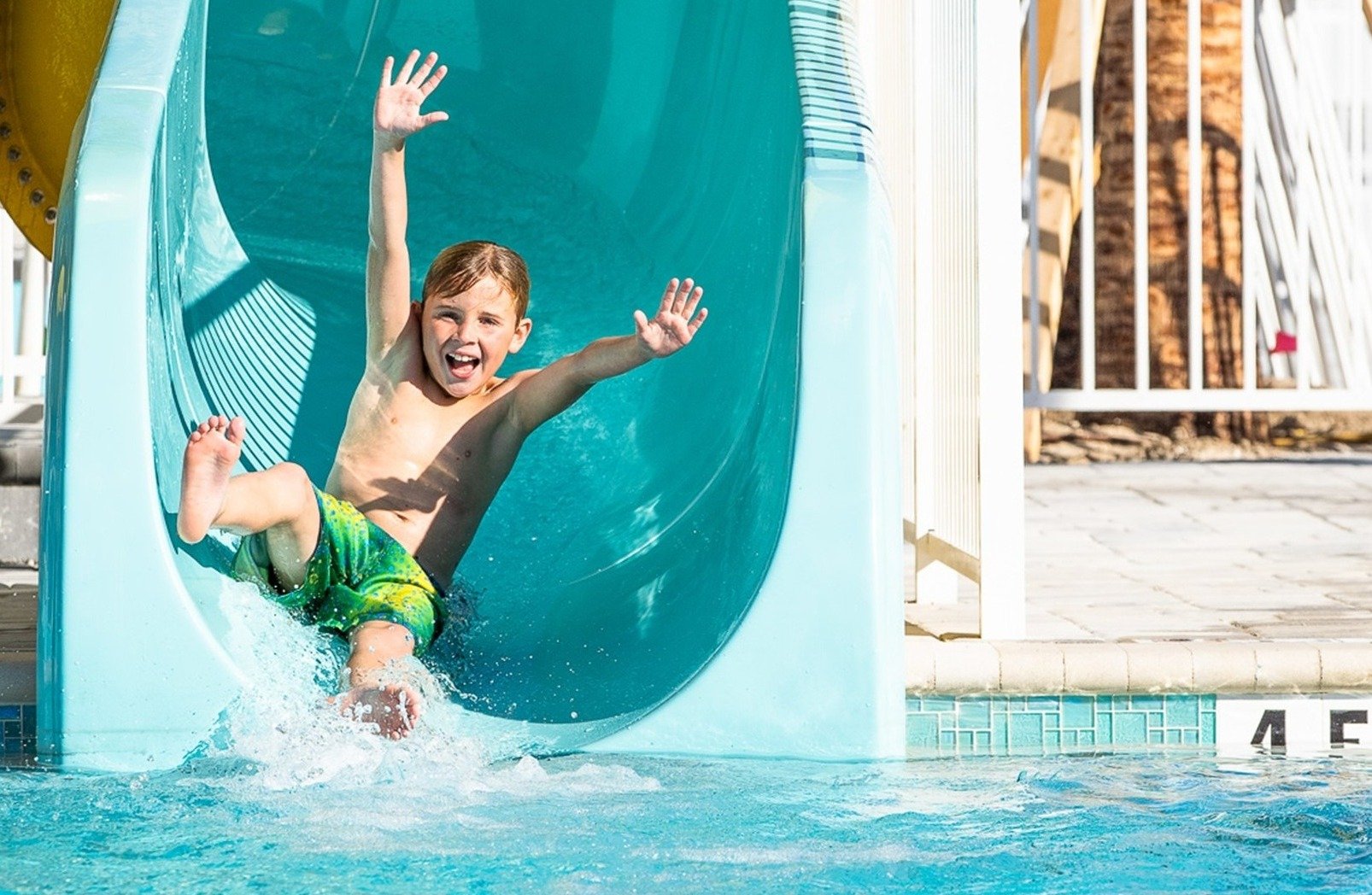 Boy sliding down a SlideWorx commercial pool slide